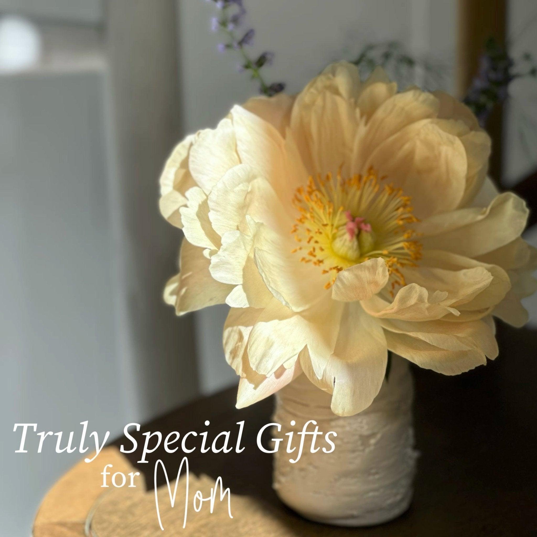 Single pale peony in a textured handmade ceramic bud vase, with the words 'Truly Special Gifts for Mom'.