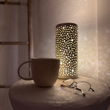 Handmade ceramic mug with deep carved vertical lines and a textured neutral glaze.