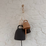 Handmade ceramic wish bell hanging in a styled home setting