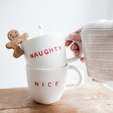 Handmade ceramic holiday mug lettered Naughty and Nice in a neutral glaze