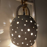 Handmade stoneware pendant lamp with hand-carved star cutouts