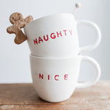 Handmade ceramic holiday mug lettered Naughty and Nice in a neutral glaze