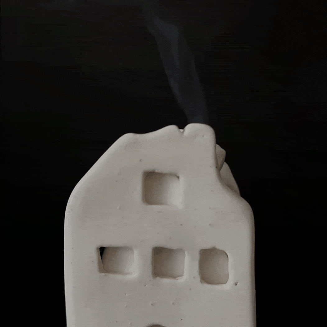 Ceramic house-shaped incense cone burner with an interior dish