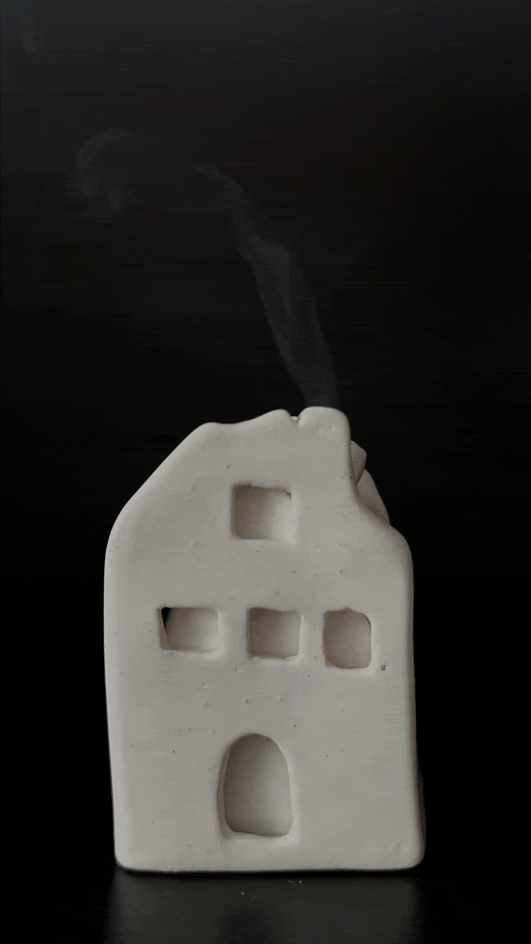 Ceramic house-shaped incense cone burner with an interior dish