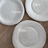 Neutral ceramic dinnerware with lace texture and raw-shaped edges