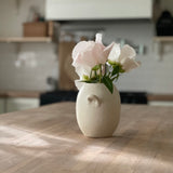 Handmade ceramic bud vase with a bellied shape and small handle