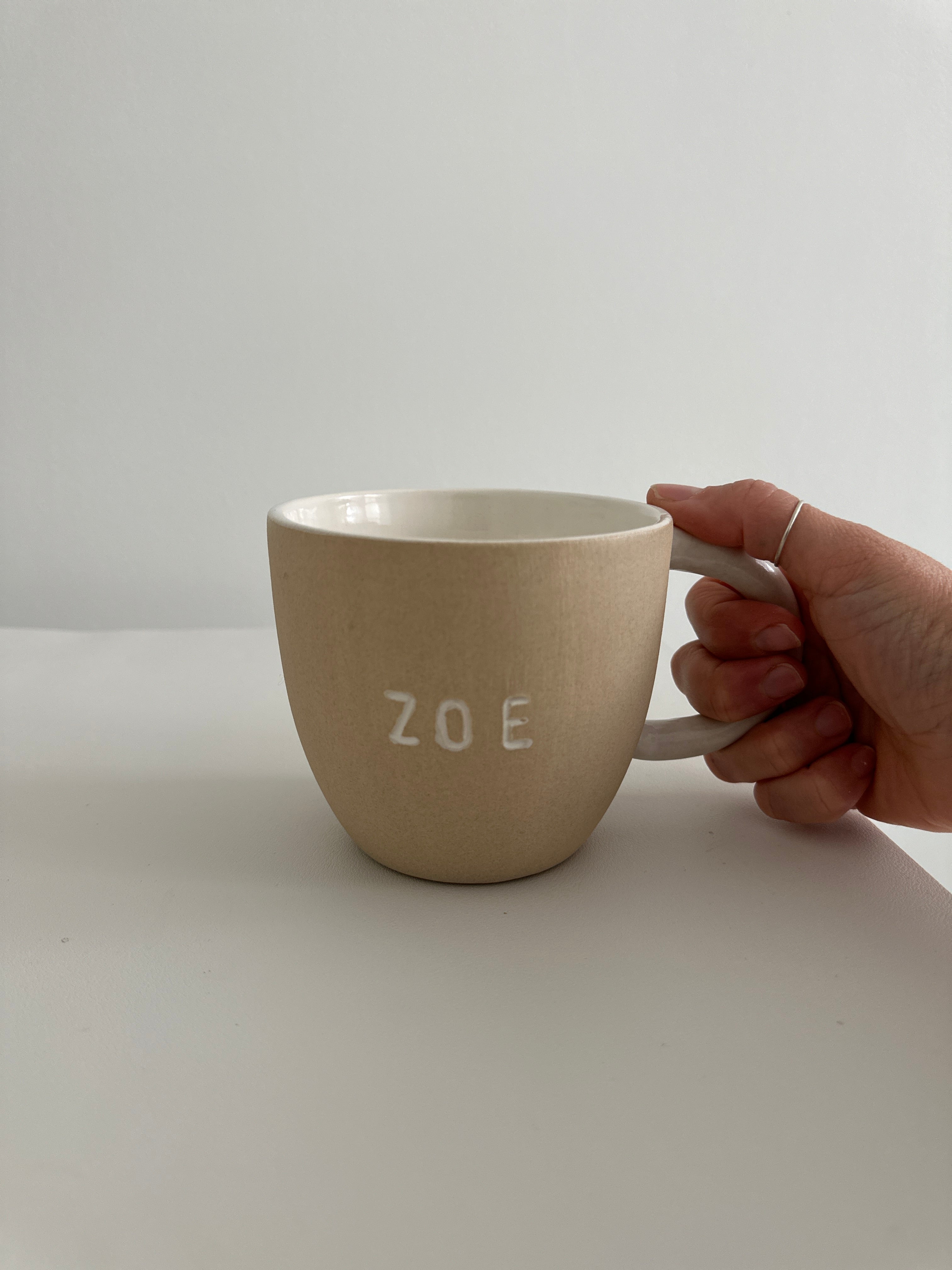 Personalized deep ceramic mug hand-lettered with a name in an earthy neutral tone