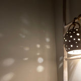 Handmade stoneware pendant lamp with hand-carved star cutouts
