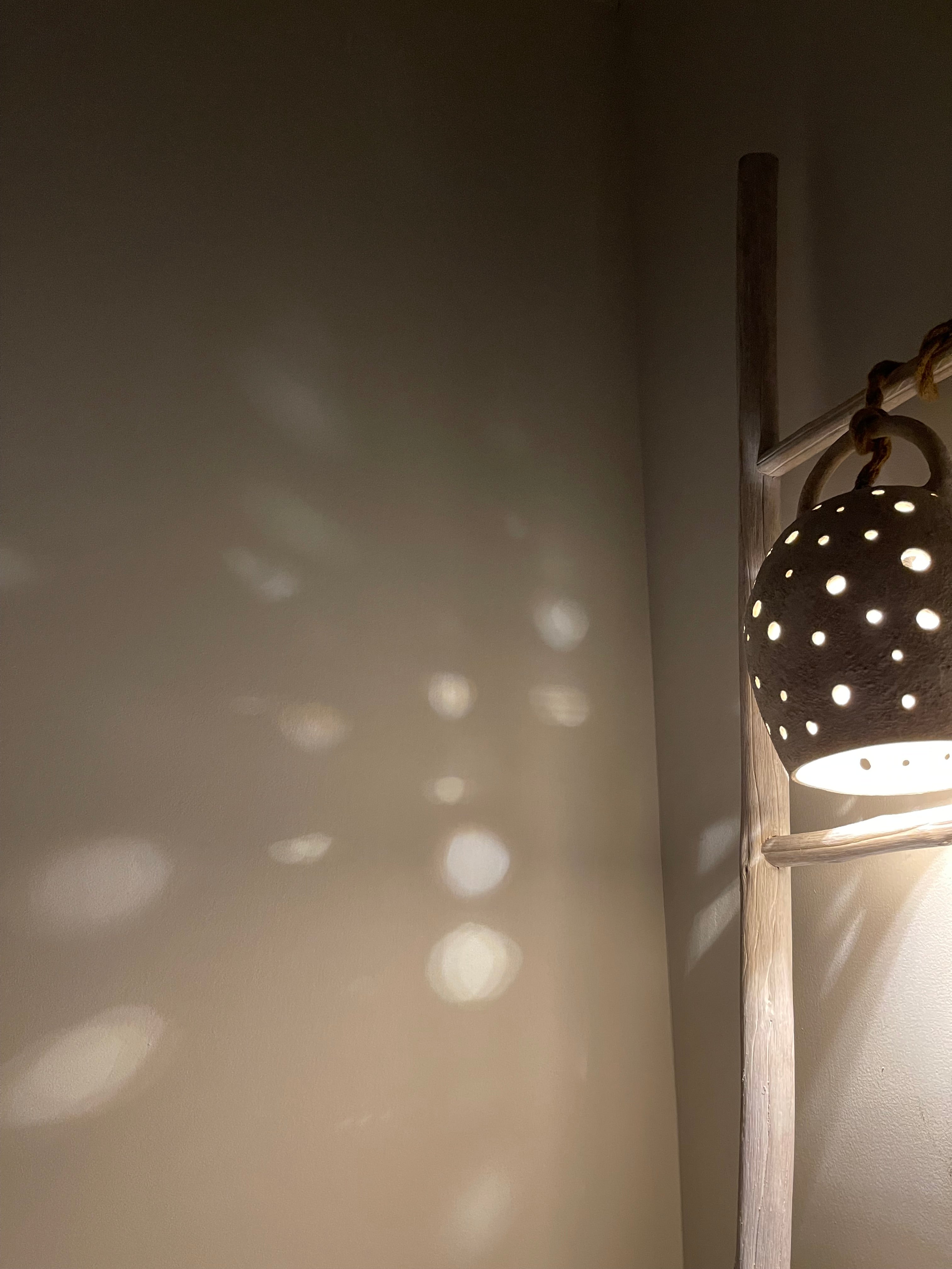 Handmade stoneware pendant lamp with hand-carved star cutouts