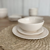 Rustic-edge ceramic dinner plate in a smooth neutral glaze
