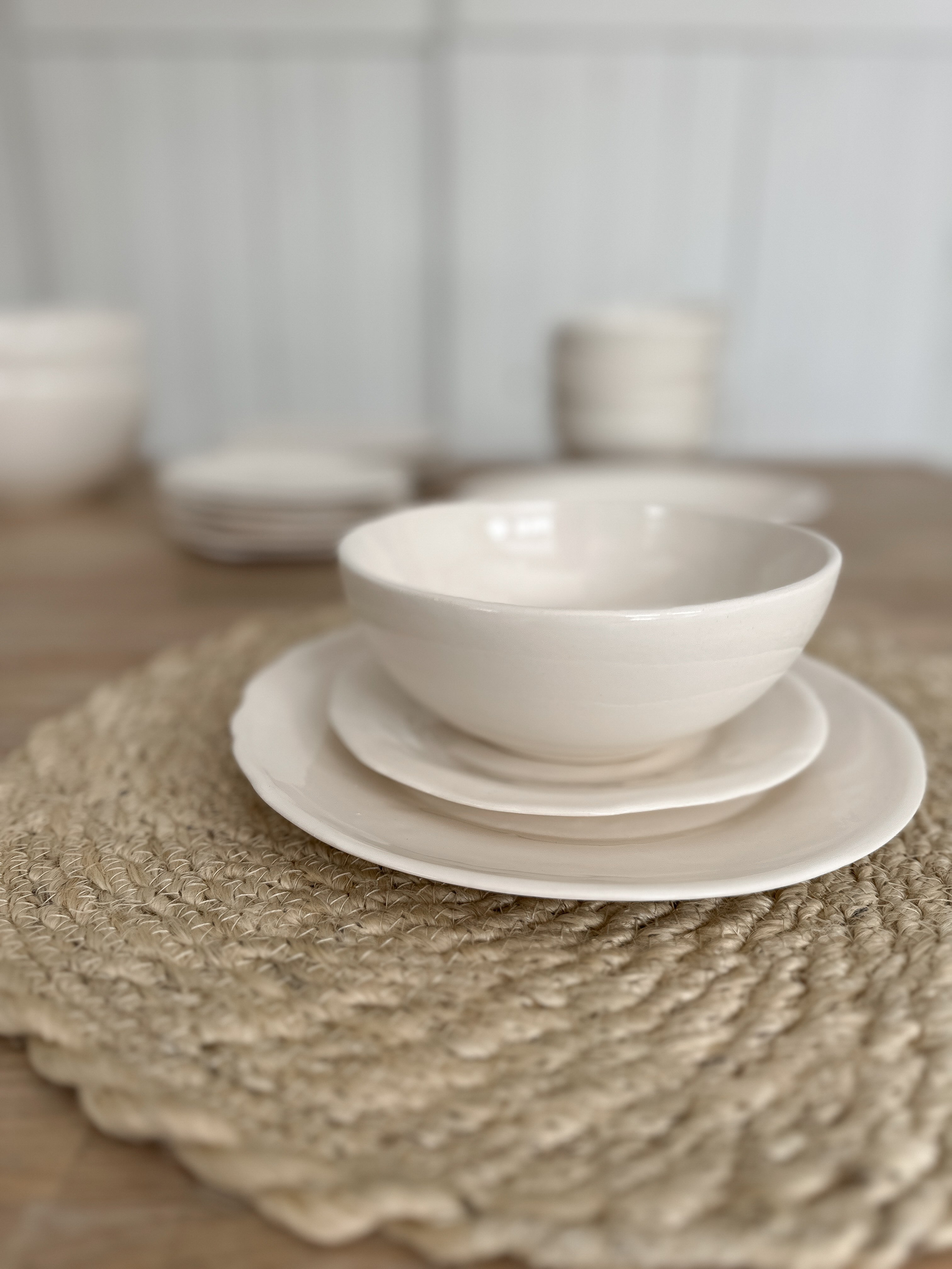 Rustic-edge ceramic dinner plate in a smooth neutral glaze