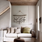 Artistic wall hanging with ceramic discs suspended from driftwood