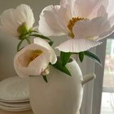 Handmade ceramic bud vase with a bellied shape and small handle