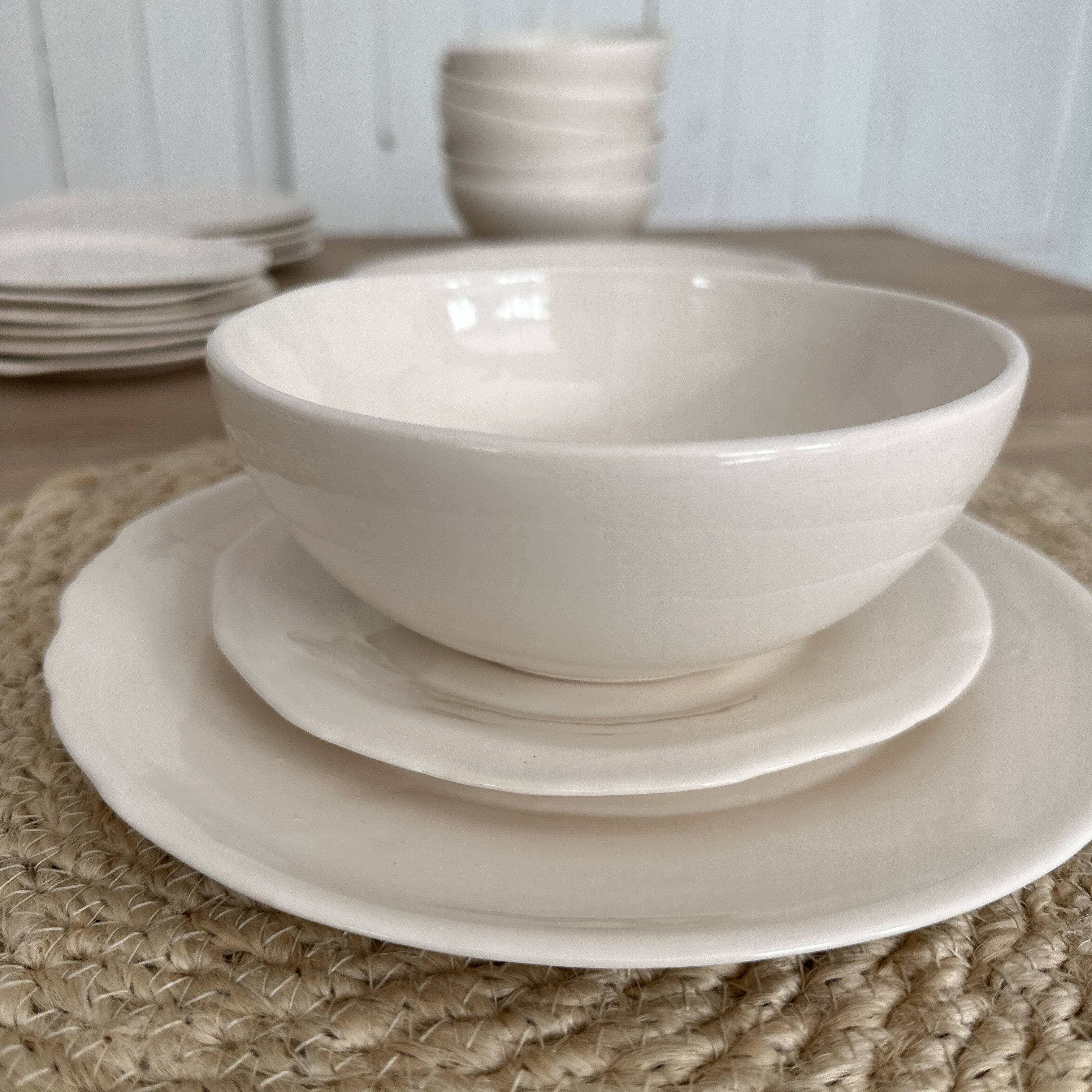 Handmade white stoneware dinner plate with a rustic raw edge
