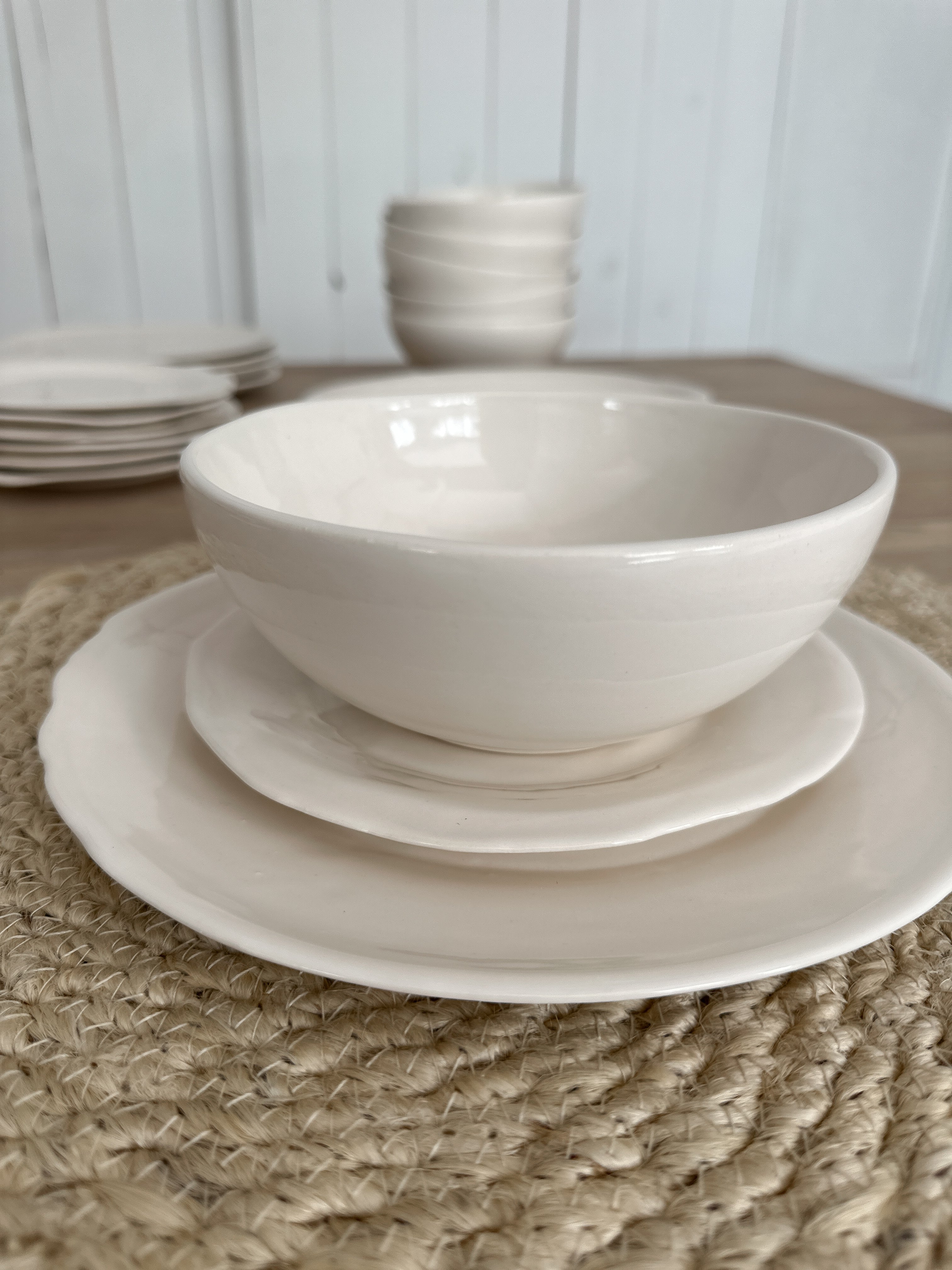 Handmade white stoneware dinner plate with a rustic raw edge