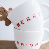 Handmade ceramic holiday mug lettered Merry and Bright in a neutral glaze