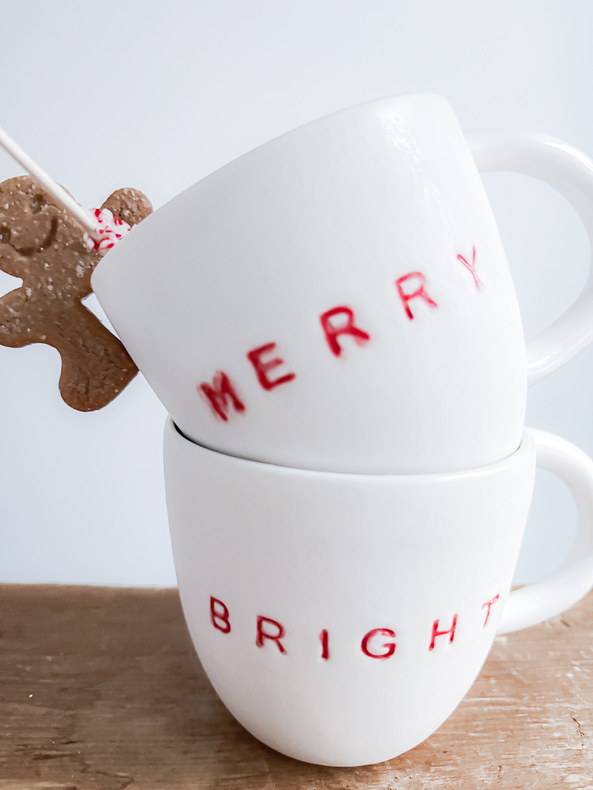 Handmade ceramic holiday mug lettered Merry and Bright in a neutral glaze