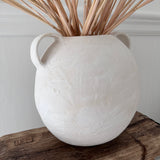 Handmade globe-shaped ceramic vessel with handles in a neutral glaze