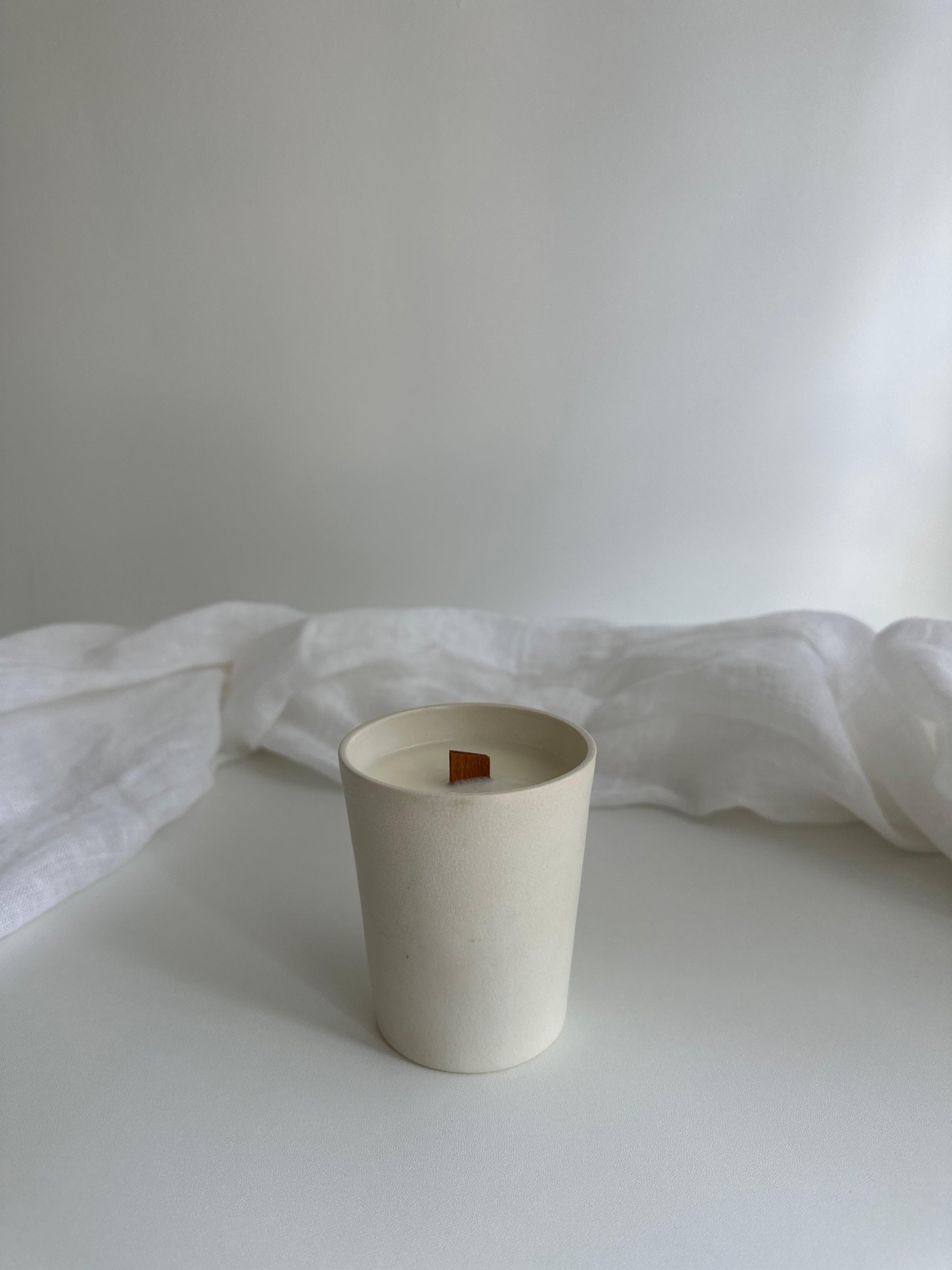 Reusable carved-star ceramic candle vessel in a neutral finish