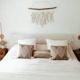Neutral ceramic disc mobile suspended from natural driftwood