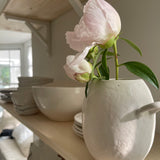 Handmade ceramic bud vase with a bellied shape and small handle
