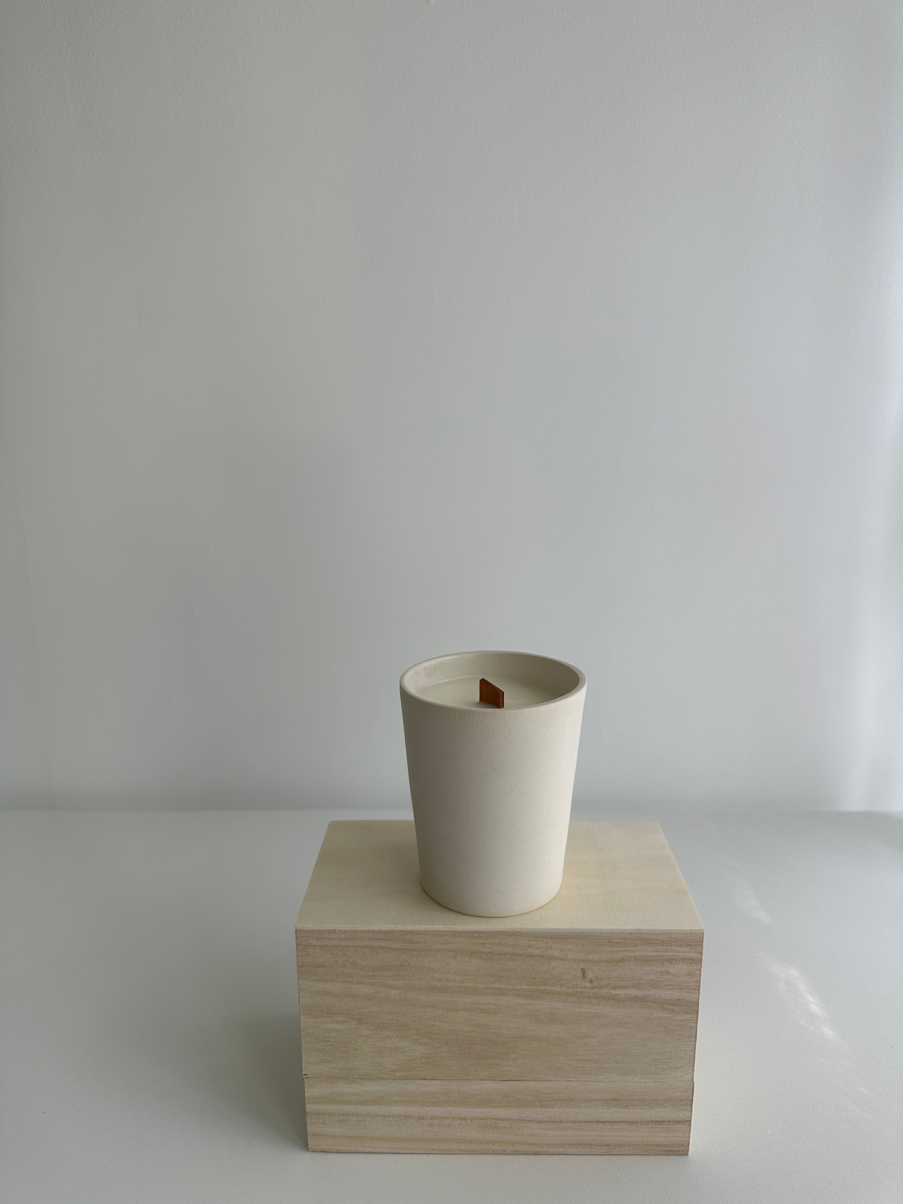 Handmade soy candle in a stoneware tumbler with star detailing