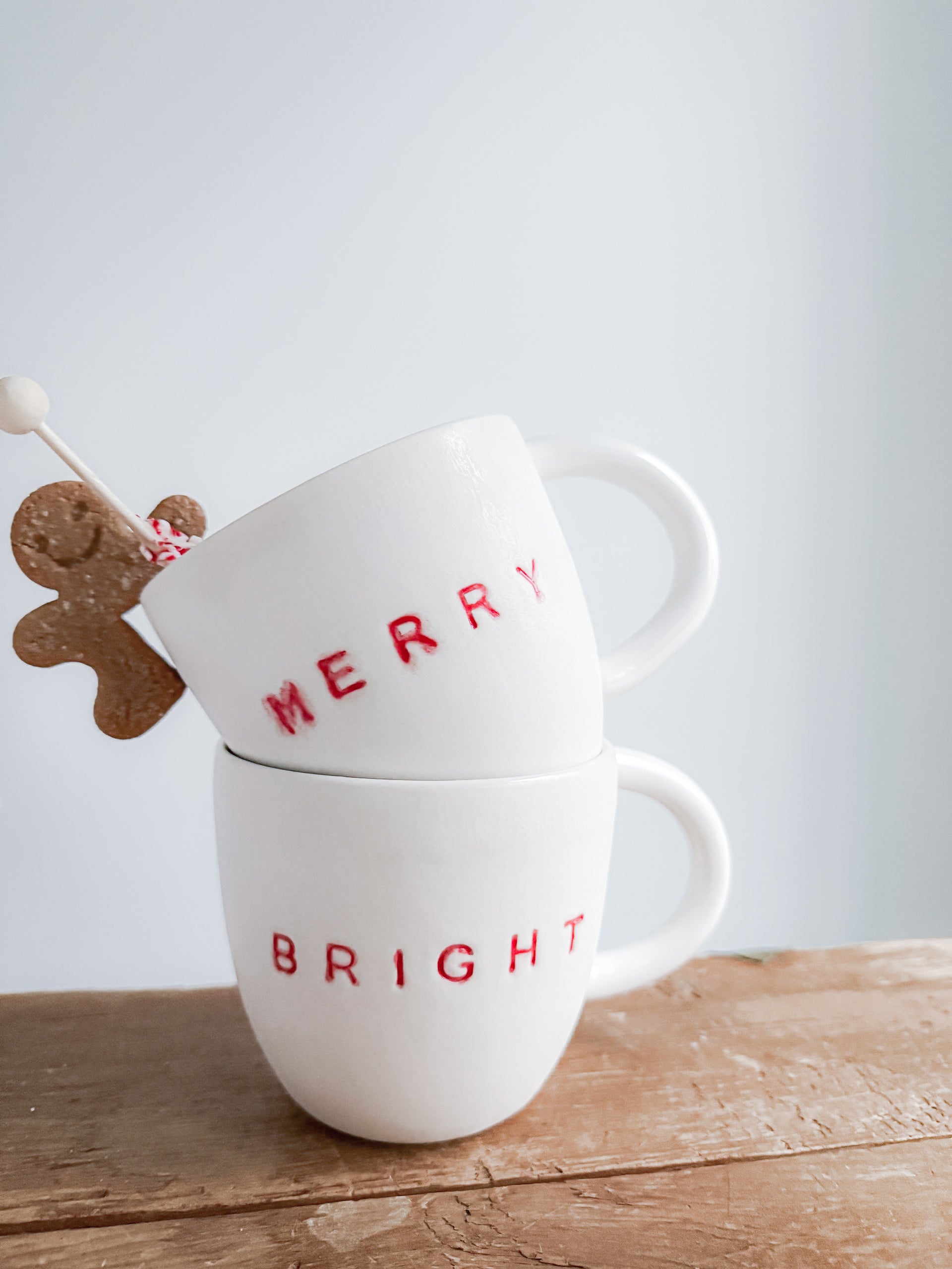 Handmade ceramic holiday mug lettered Merry and Bright in a neutral glaze