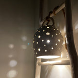 Handmade stoneware pendant lamp with hand-carved star cutouts