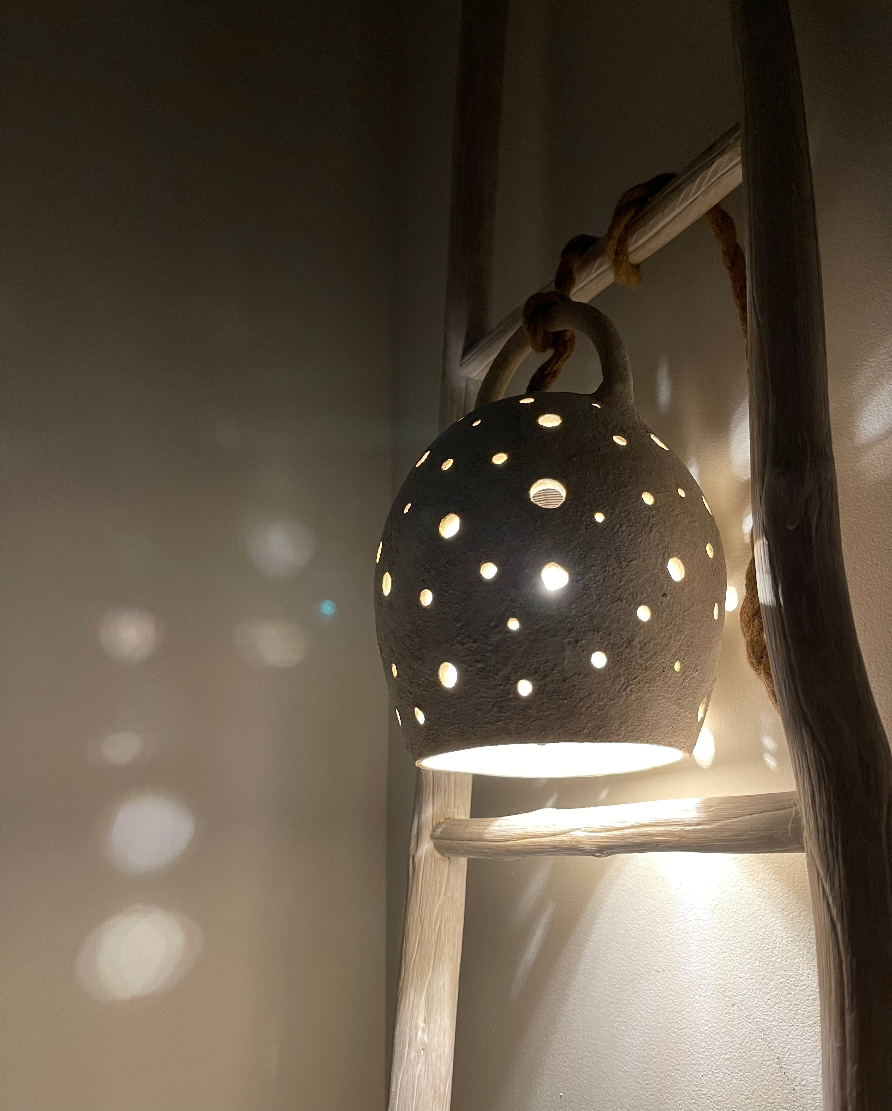 Handmade stoneware pendant lamp with hand-carved star cutouts