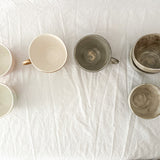 Handmade ceramic mug with a warm neutral glaze, seconds sale