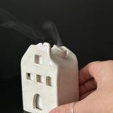 Ceramic house-shaped incense burner in a neutral glaze