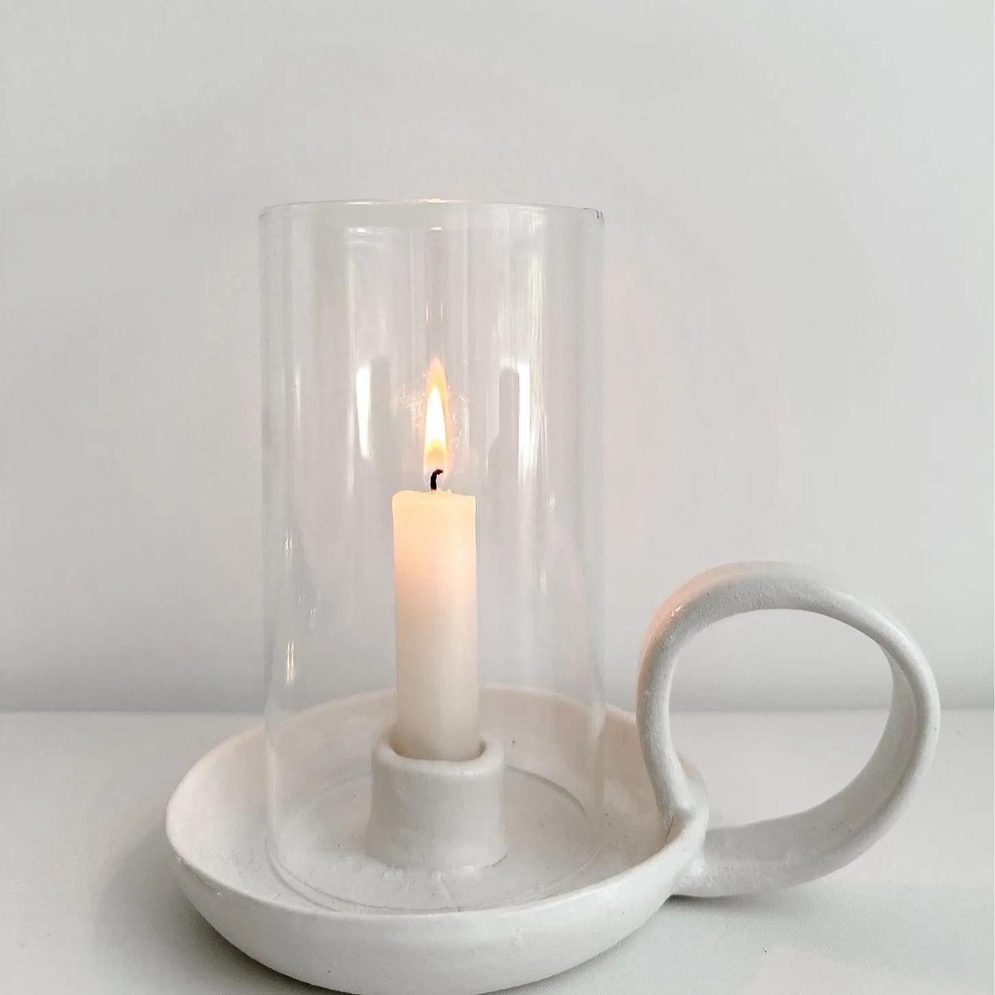 Handmade ceramic looped candle holder with a glass hurricane cover