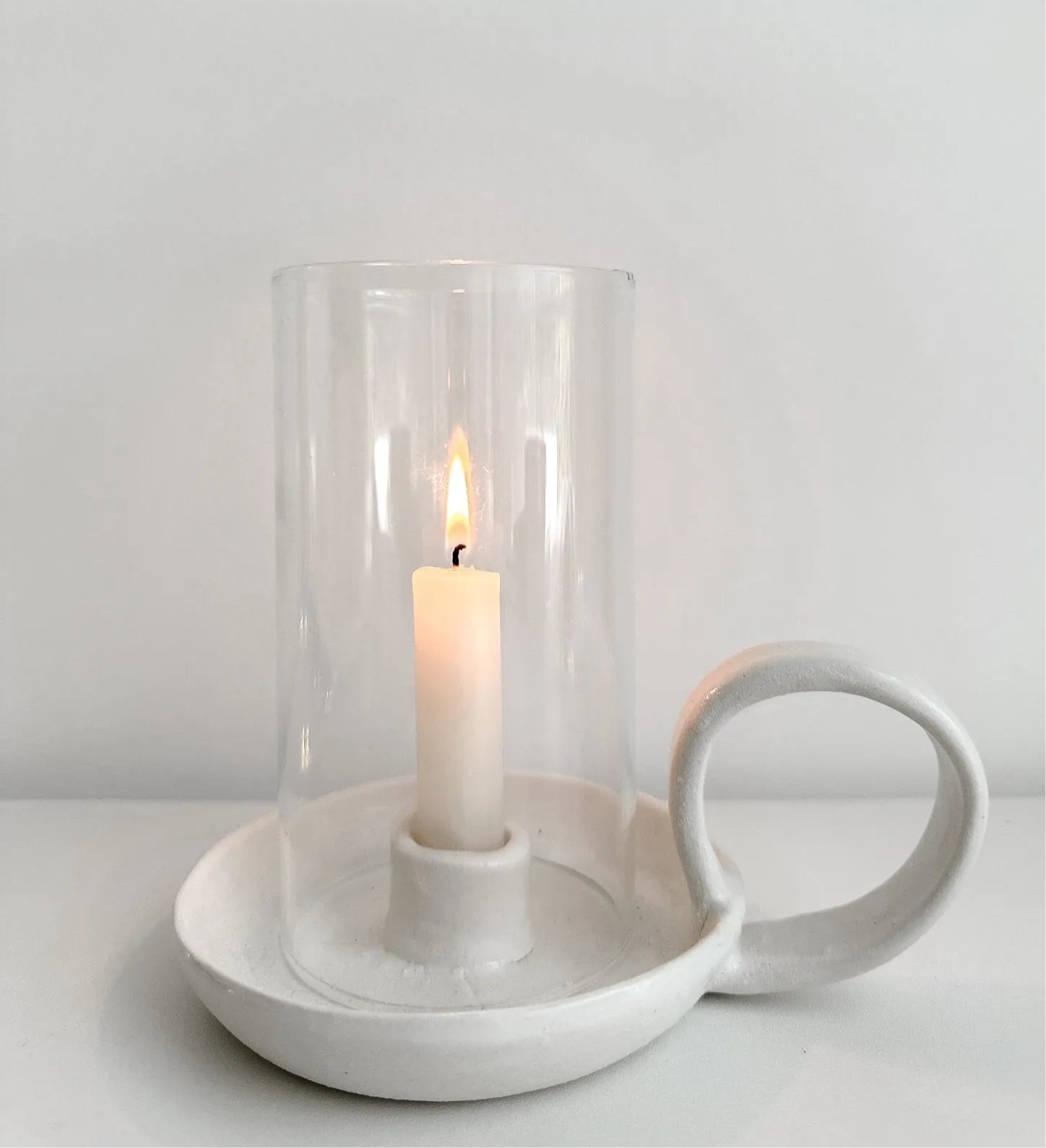 Handmade ceramic looped candle holder with a glass hurricane cover