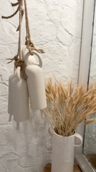 Handmade long ceramic bell with an elongated silhouette in a neutral finish