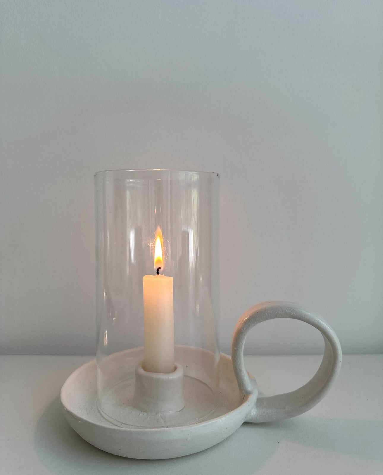Looped ceramic hurricane candle holder in a neutral finish