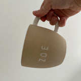Handmade personalized name mug, close-up of the hand-lettered text