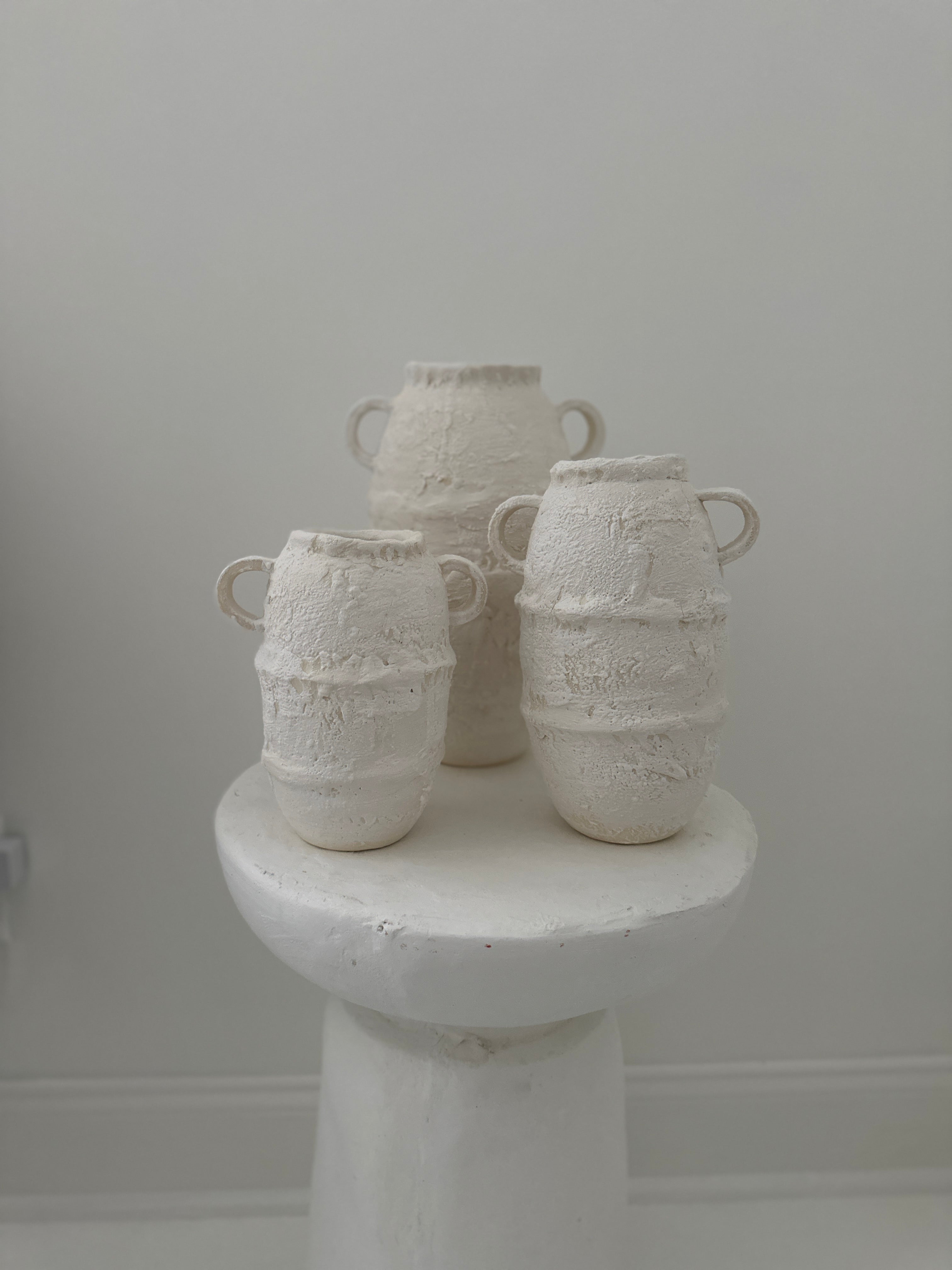 Artisan-crafted ceramic vases with a textured surface