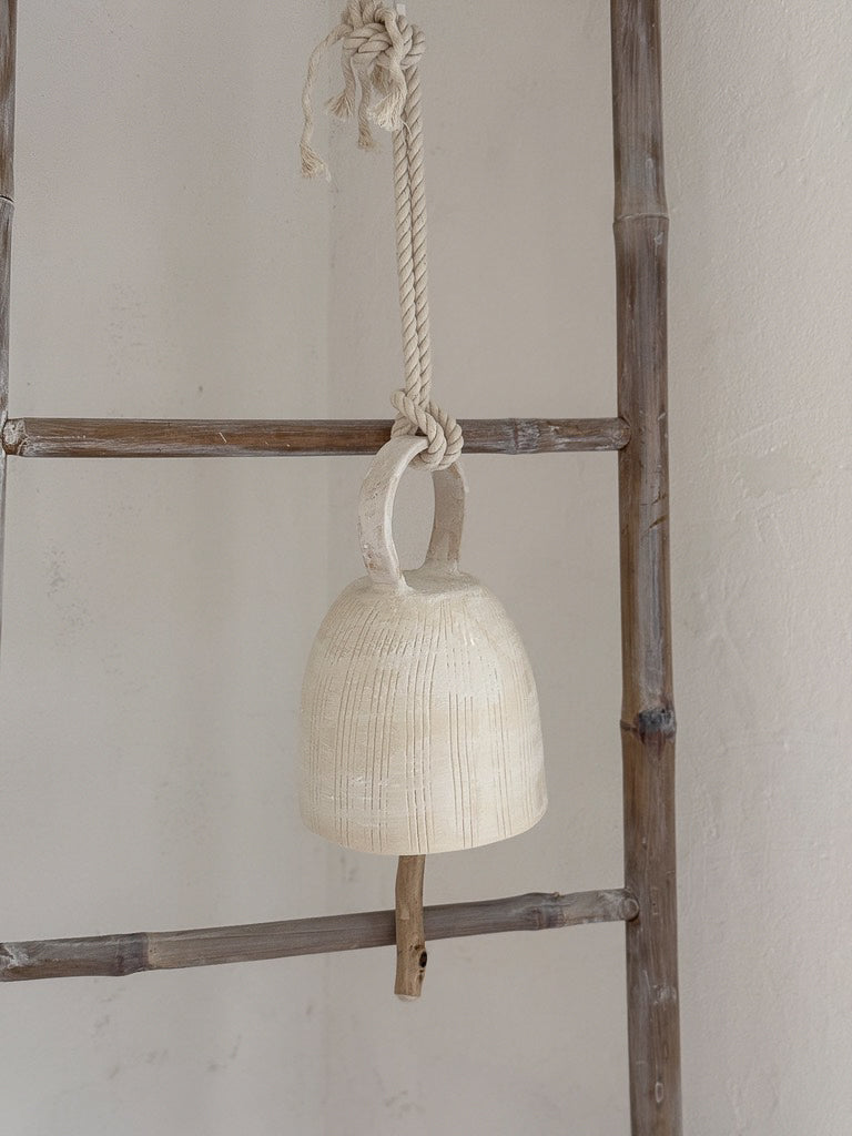 Handmade hanging ceramic bell with a handle and foraged wood clapper