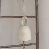 Handmade hanging ceramic bell with a handle and foraged wood clapper
