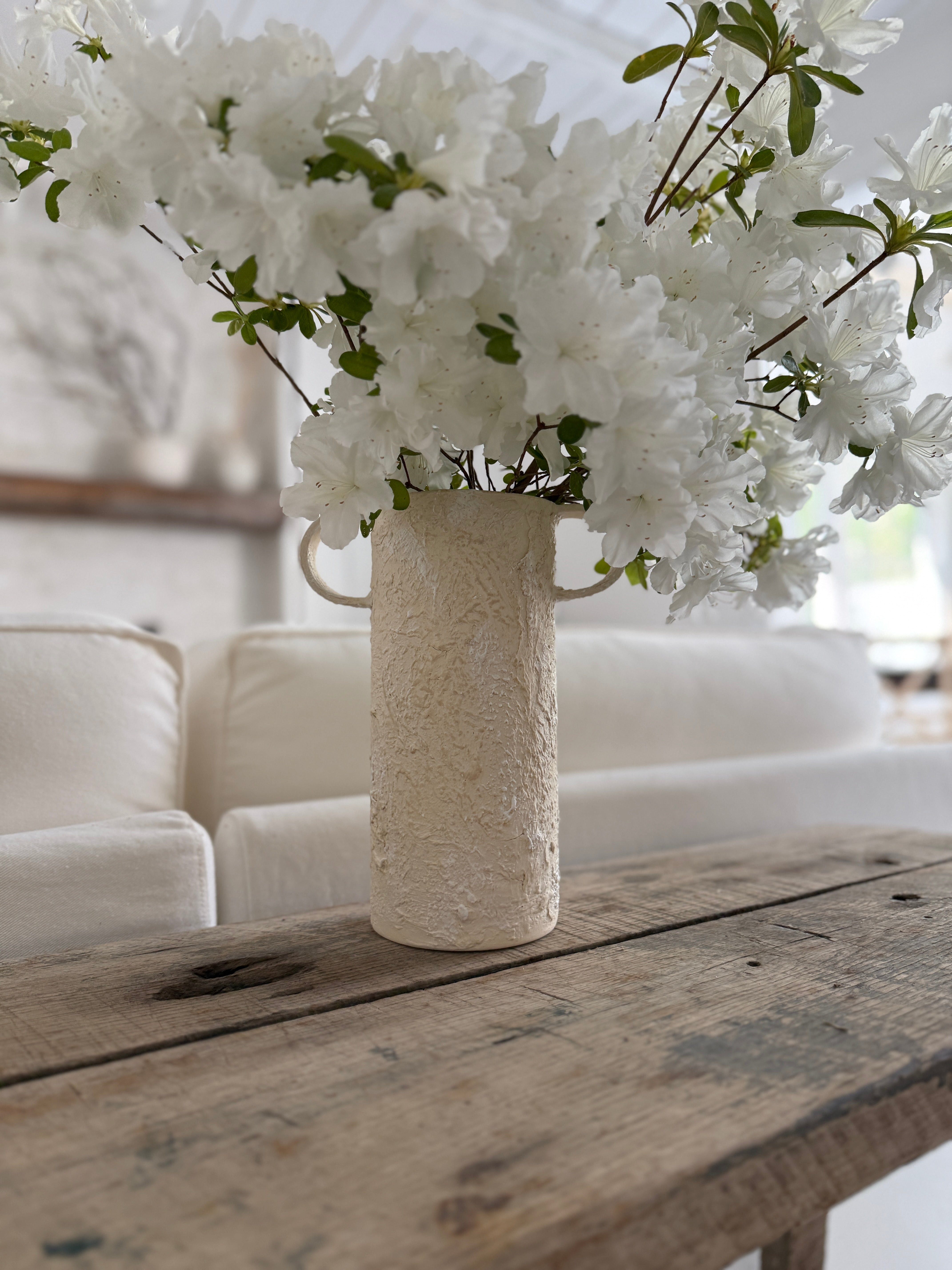 Handmade tall ceramic vessel with a handle for long-stemmed flowers
