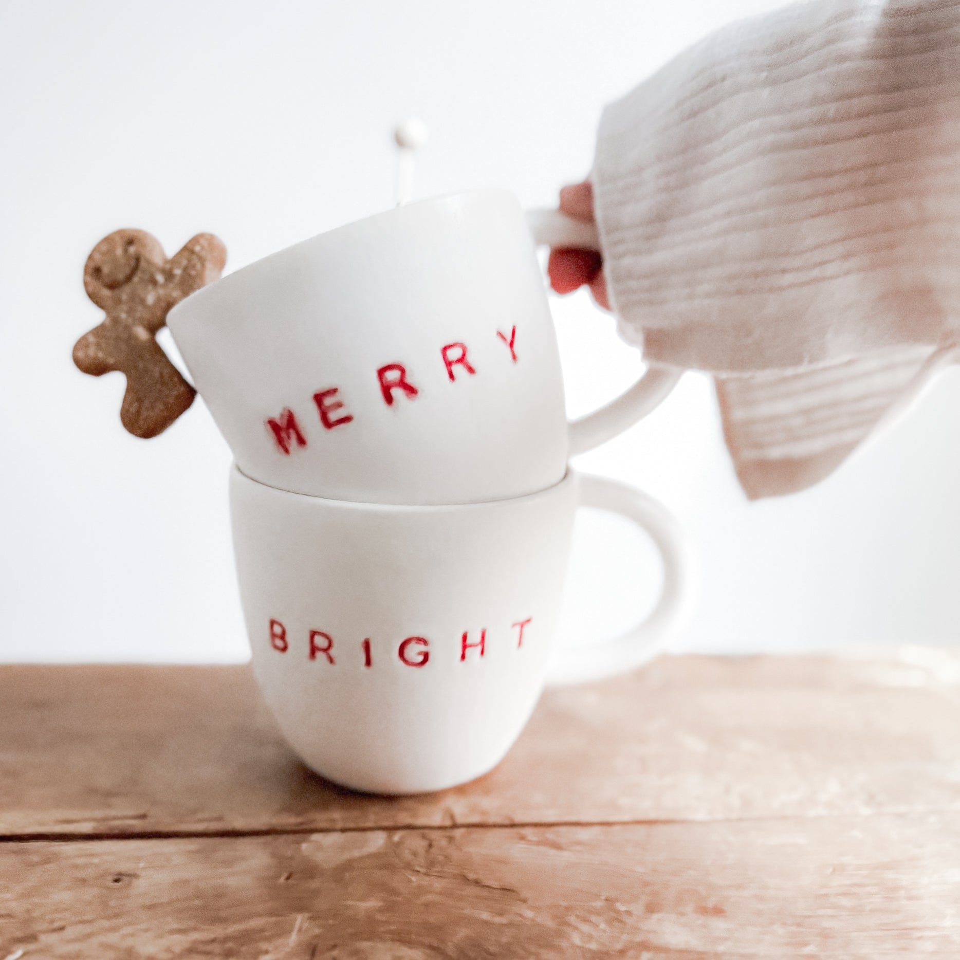 Handmade ceramic holiday mug lettered Merry and Bright in a neutral glaze