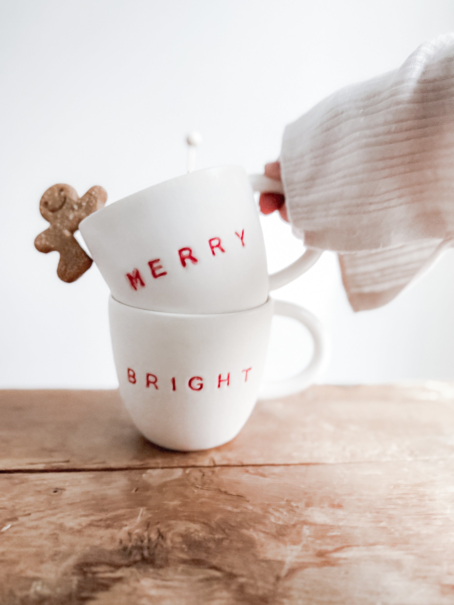Handmade ceramic holiday mug lettered Merry and Bright in a neutral glaze