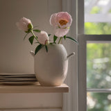 Handmade ceramic bud vase with a bellied shape and small handle