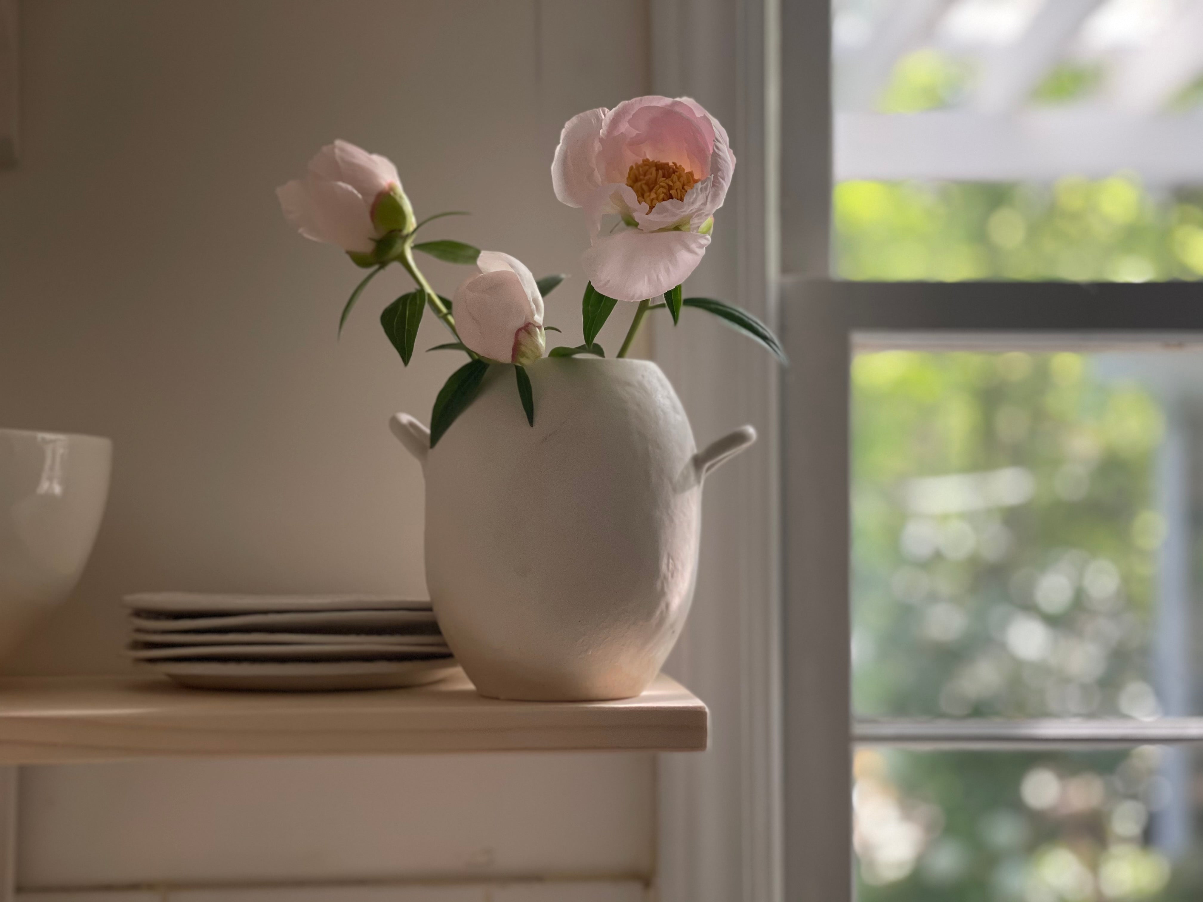 Handmade ceramic bud vase with a bellied shape and small handle