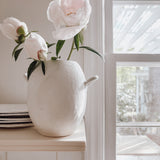 Handmade ceramic bud vase with a bellied shape and small handle