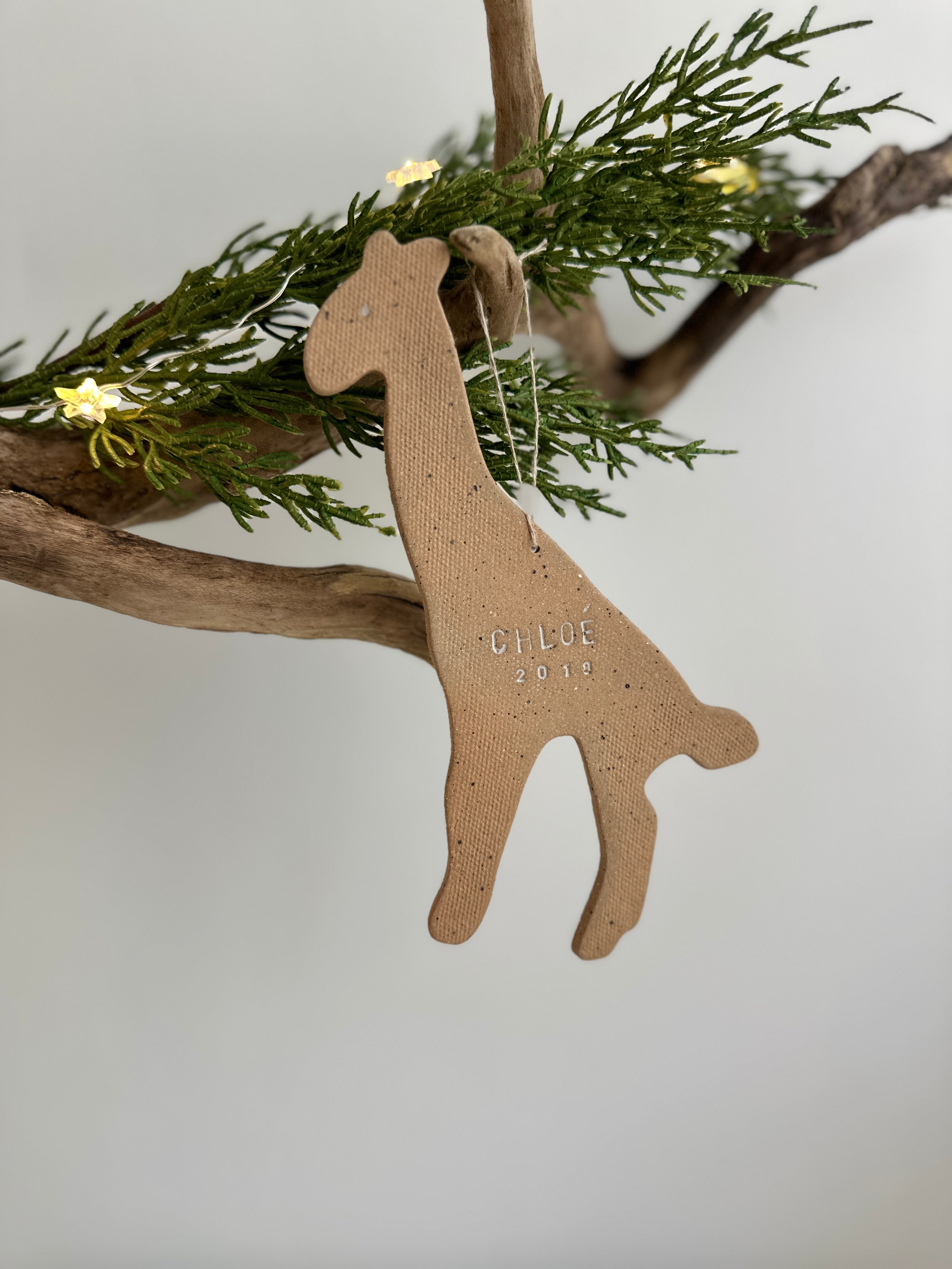 Personalized ceramic giraffe ornament with a custom name, a handmade baby keepsake ornament