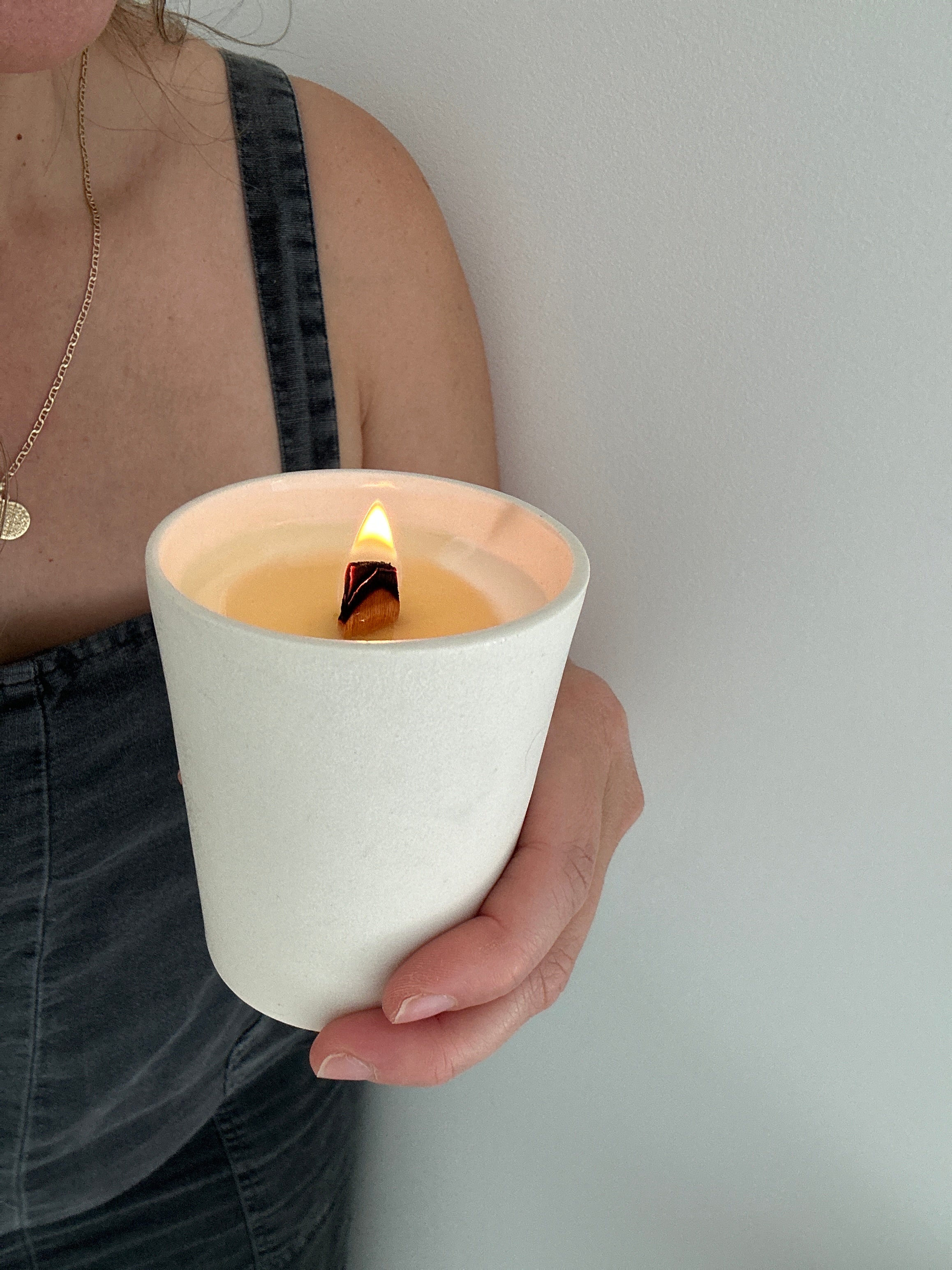 Hand-poured soy candle in a carved-star stoneware tumbler vessel