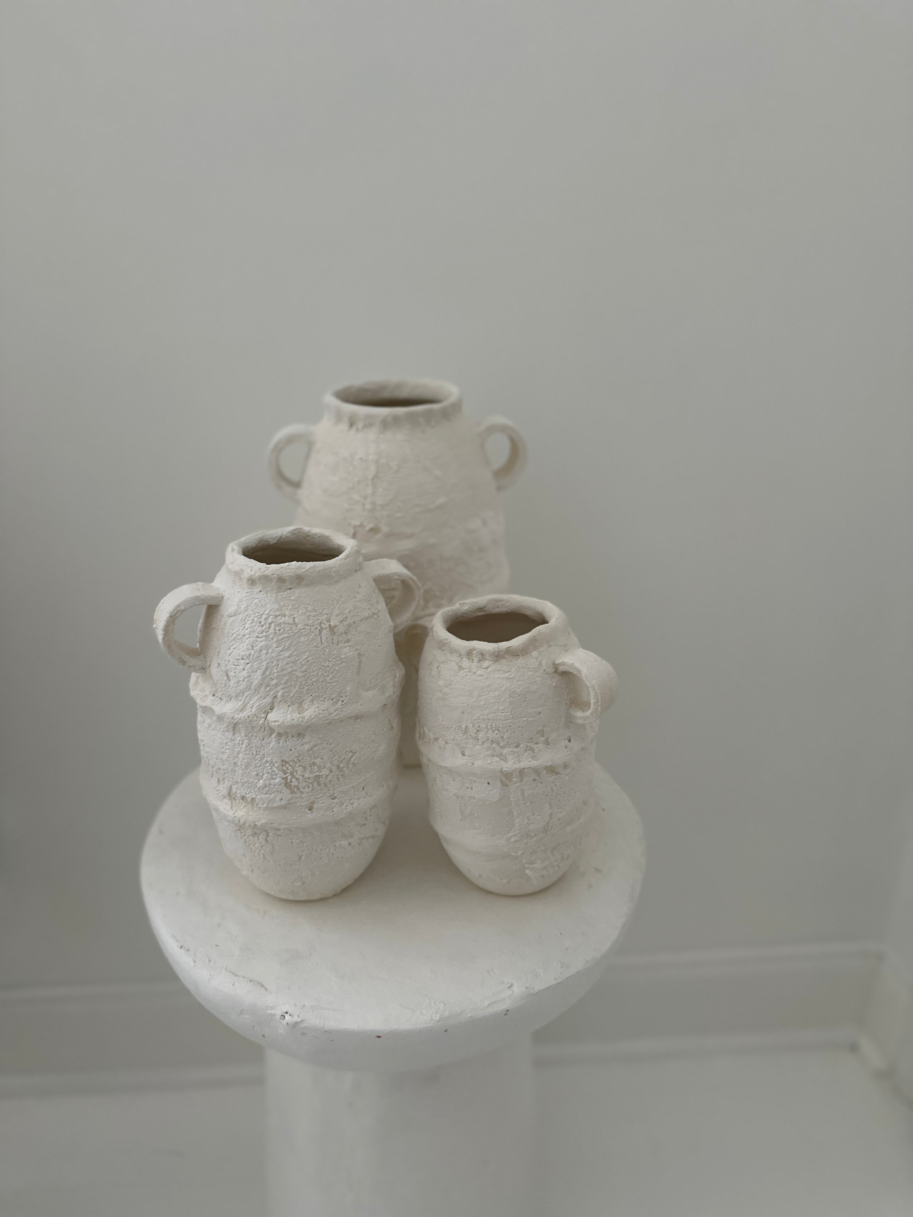 White Handmade ancient amphora style vessels  textured ceramic vases in neutral tones