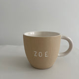 Personalized earthy ceramic mug styled with coffee