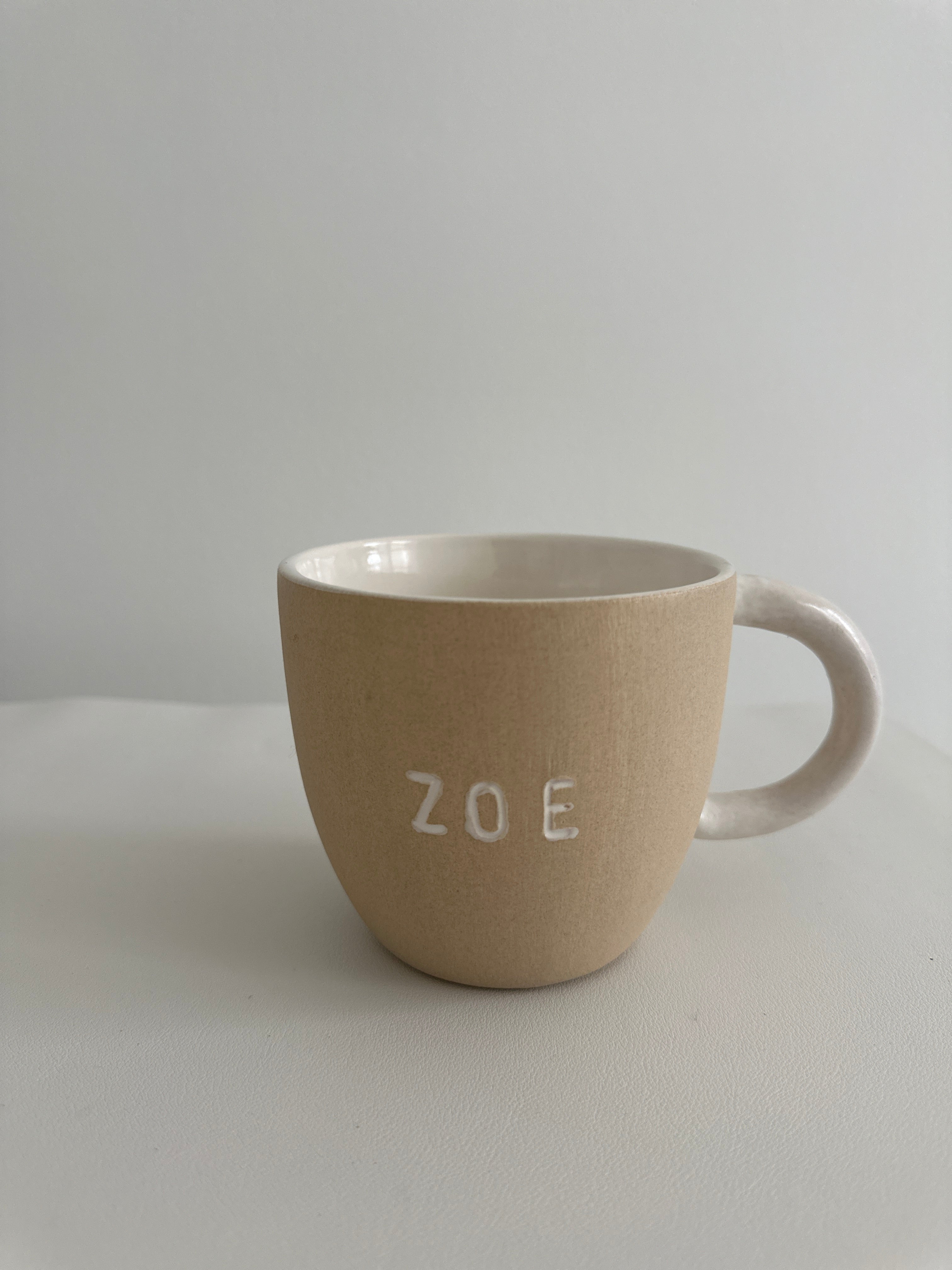 Personalized earthy ceramic mug styled with coffee